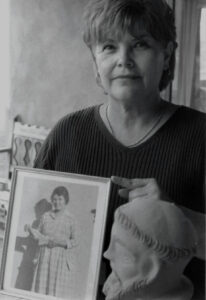 Quirina-w-photo-of-Isabel Quirina Córdova Medina holding a photo of her grandmother Isabel Córdova.