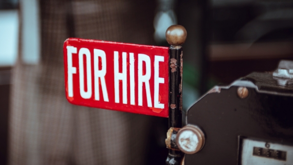 A red sign reads "For Hire".